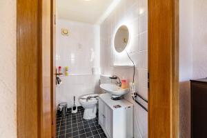 a small bathroom with a toilet and a sink at Ferienhaus Eiffelperle in Kaisersesch +26 photos