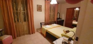 a small bedroom with a bed and a mirror at Margarita's house in Sami +6 photos
