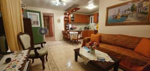 a living room with a couch and a table at Margarita's house in Sami