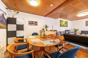 a living room with a table and chairs and a piano at Ferienhaus Eiffelperle in Kaisersesch