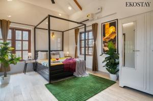 a room with a bed and a green rug at EKOSTAY - Mount Emerald Villa in Alibaug