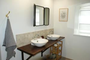 a bathroom with two sinks and two mirrors at Lustrup Farmhouse in Ribe +48 photos