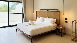 a bedroom with a bed with white sheets and pillows at Kano Boutique Hotel Paje in Paje +89 photos