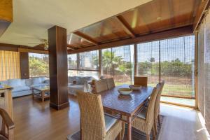 a living room with a wooden table and chairs at Villa las Terrenas in Calafell