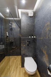 a bathroom with a toilet and a glass shower at Sote Mountain View in Samokov +49 photos