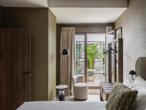 a hotel room with a bed and a balcony at Seda Residences in Granada +46 photos
