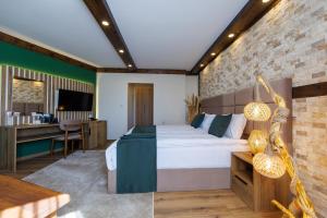 a bedroom with a large bed and a desk at Sote Mountain View in Samokov