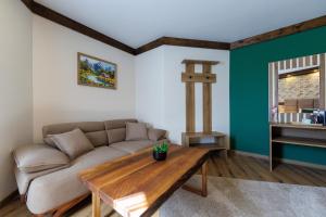a living room with a couch and a wooden table at Sote Mountain View in Samokov