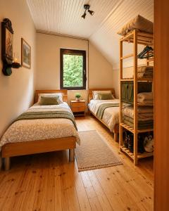 a bedroom with two bunk beds and a window at Biocinovici vikendica in Kolašin