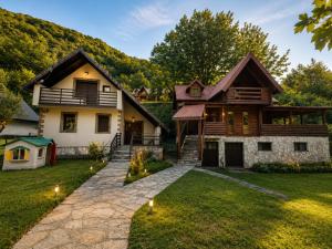 a home in the mountains with a stone pathway at Biocinovici vikendica in Kolašin