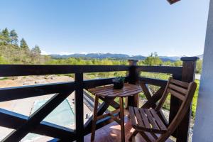 a table and two chairs on a balcony with a view at Sote Mountain View in Samokov