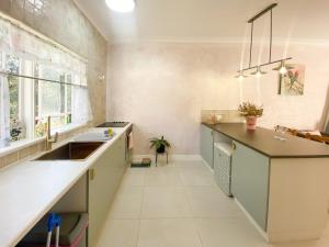 a kitchen with a sink and a counter at Wisteria Hideaway in Coffs Harbour