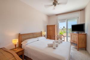 a bedroom with a bed and a flat screen tv at Villa las Terrenas in Calafell +27 photos