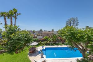 an overhead view of a swimming pool in a yard with trees at Villa las Terrenas in Calafell