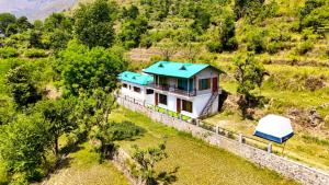 an aerial view of a house with a blue roof at Kabila King Resort in Chakrāta