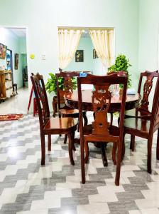 a dining room with a wooden table and chairs at Cali Homestay Tây Ninh in Tây Ninh