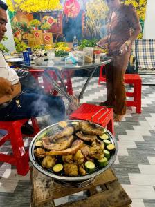 a pan of food on top of a table at Cali Homestay Tây Ninh in Tây Ninh
