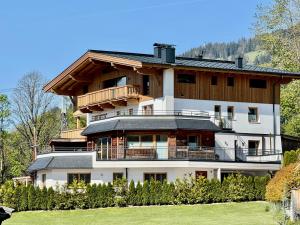 a large white building with a balcony at Bergpanorama in Brixen im Thale
