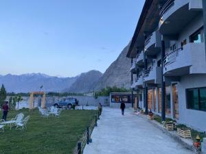 a person walking down a sidewalk next to a building at Eat and Read Hotel in Skardu +23 photos