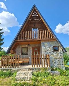 a small cabin with a roof with a wooden fence at Koliba BUKOVICA in Šavnik