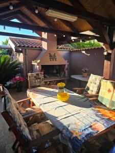a table and chairs on a patio with an outdoor oven at Malinsummer Apartments in Malinska