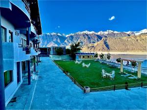 an aerial view of a resort with mountains in the background at Eat and Read Hotel in Skardu