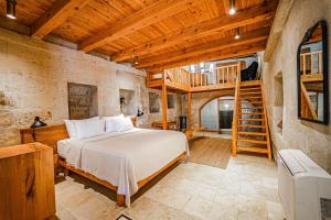 a bedroom with a bed and a staircase at Sedirli Konak 1751 Special Class in Ürgüp