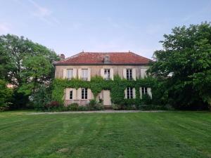 an old house with ivy on the side of a yard at Domaine de Chaunac in Chaunac