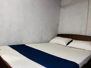 a bedroom with a bed with a blue and white blanket at Sea secret in Arugam Bay