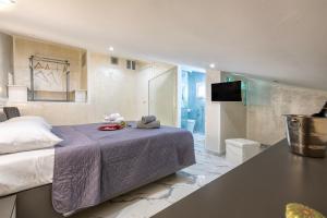 a bedroom with a large bed and a bathroom at Prestige House in Nulvi