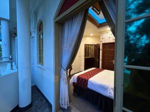 a bedroom with a bed in a room with a window at Palmscape Boutique Hotel in Hulhumale