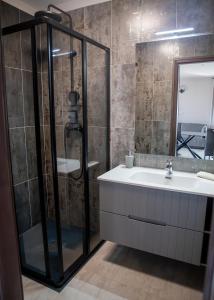 a bathroom with a shower and a sink at Maya Panzio-Rezidencia in Szeged