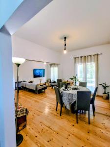 a large living room with a table and chairs at House Konstantinos in Agios Georgios