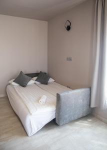 a bedroom with a large bed with a white bedvisor at Maya Panzio-Rezidencia in Szeged