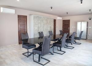 a conference room with a long table and chairs at Maya Panzio-Rezidencia in Szeged