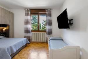 a bedroom with a bed and a flat screen tv at Villa Giusy in Verdellino