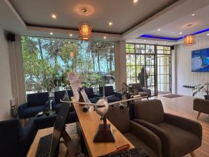 a living room with a table and chairs at Palmscape Boutique Hotel in Hulhumale