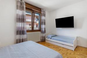 a bedroom with a bed and a flat screen tv at Villa Giusy in Verdellino