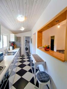 a kitchen with a black and white checkered floor at House Konstantinos in Agios Georgios
