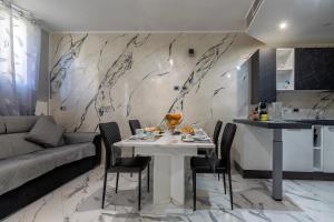 a dining room with a white table and chairs at Prestige House in Nulvi