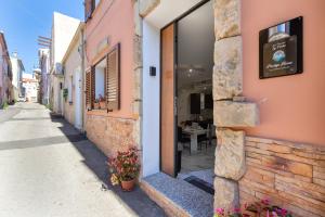 a building with a door on the side of a street at Prestige House in Nulvi