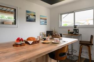 a kitchen with a wooden counter with bread on it at Chambre d'hôtes Spiren in Baden