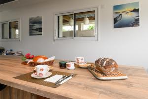 a table with bread and croissants on it at Chambre d'hôtes Spiren in Baden +12 photos