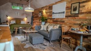a living room with a couch and a bed at Tin Bath As Glorious as its Namesake in Aller