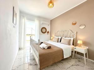 a bedroom with a white bed and a window at Lilu Villa 2 with Private Pool and Seaview in Tigaki +26 photos