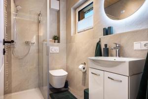 a bathroom with a toilet sink and a shower at Ferienhaus Auerberg Sweet in Stötten am Auerberg +12 photos