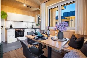 a kitchen and dining room with a table and chairs at Ferienhaus Auerberg Sweet in Stötten am Auerberg
