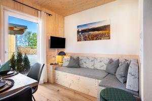 a living room with a couch and a window at Ferienhaus Auerberg Sweet in Stötten am Auerberg