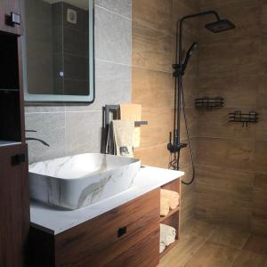 a bathroom with a white sink and a shower at Guest House ELIYA in Devin +26 photos