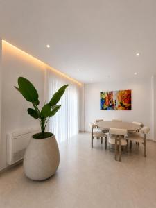 a living room with a table and a potted plant at Villa Azur in Draç